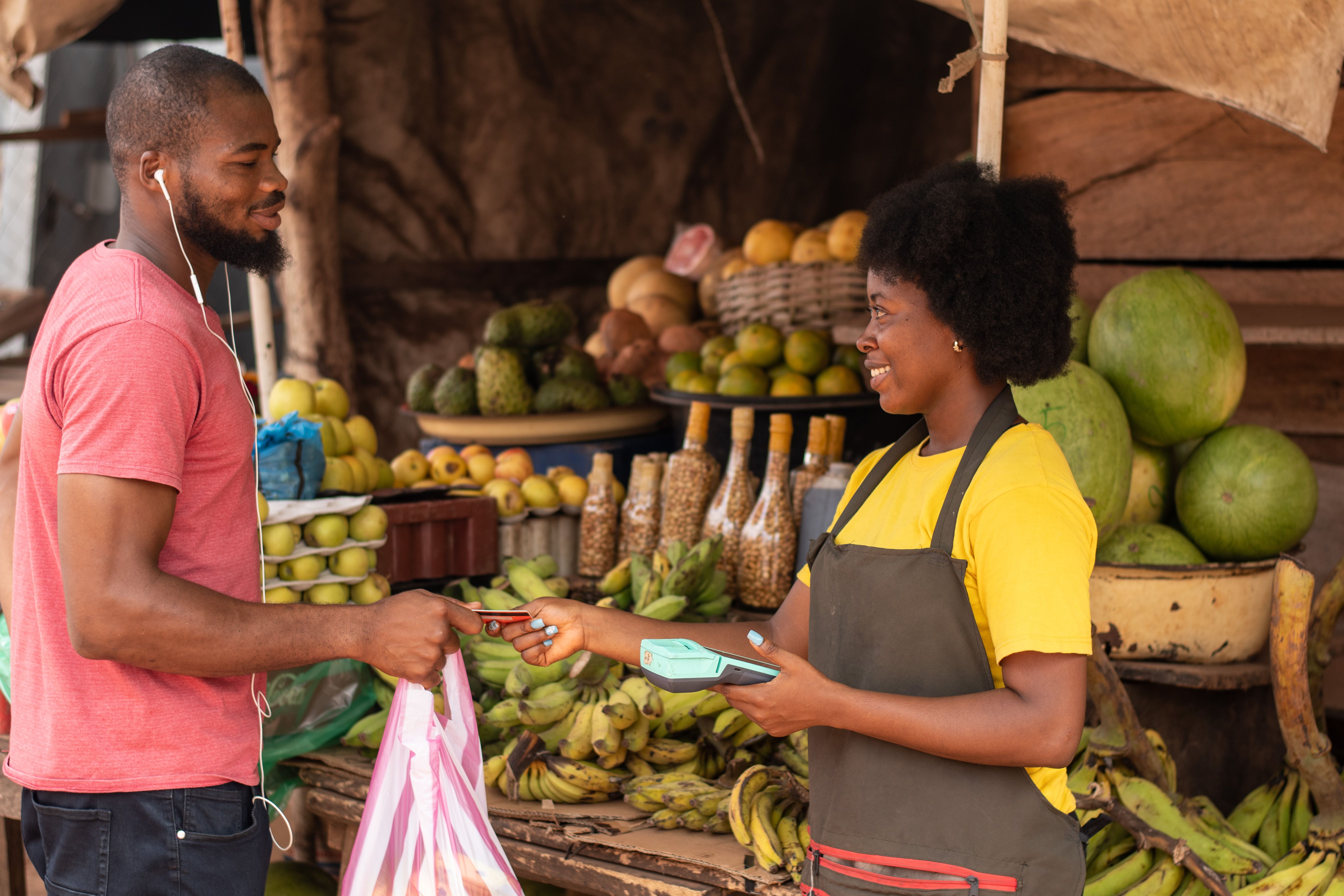 woman selling in a market collecting credit card